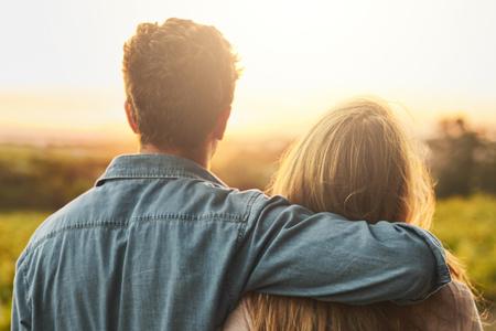 Man putting arm around lady's neck