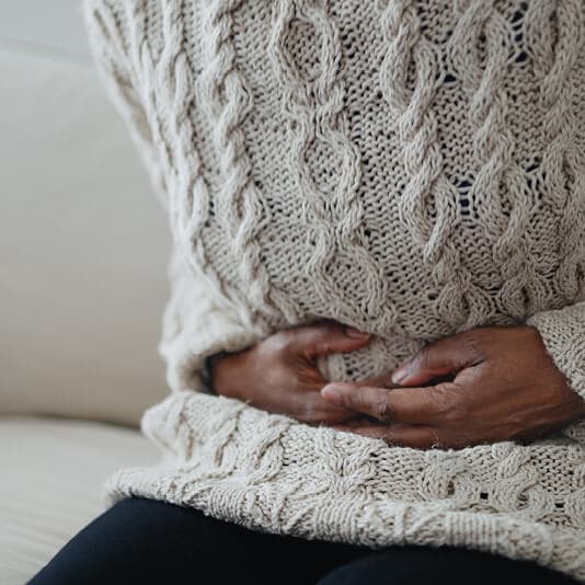 Woman holding stomach in pain