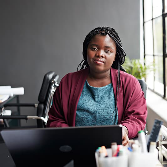 Visually impaired woman working at laptop