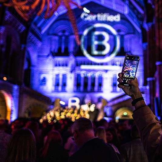 B Corp logo projected on walls of the Natural History Museum