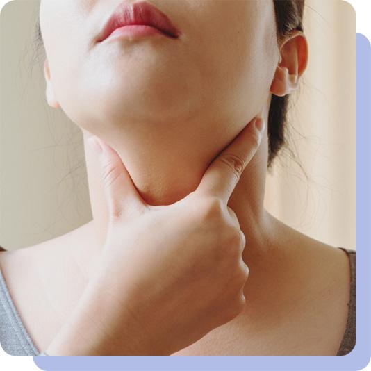 A woman examining her neck using her hand