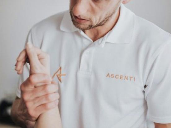 Ascenti physiotherapist inspecting a patient's wrist