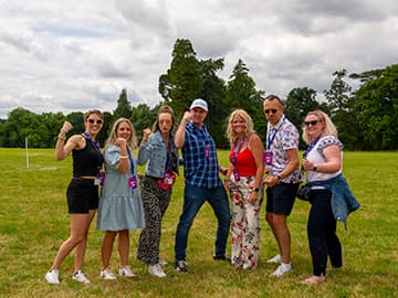 A group of Simplyhealth colleagues stood in a line, flexing their arms