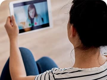 Woman having a GP video appointment on her tablet device