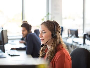 Woman in office wearing a headset