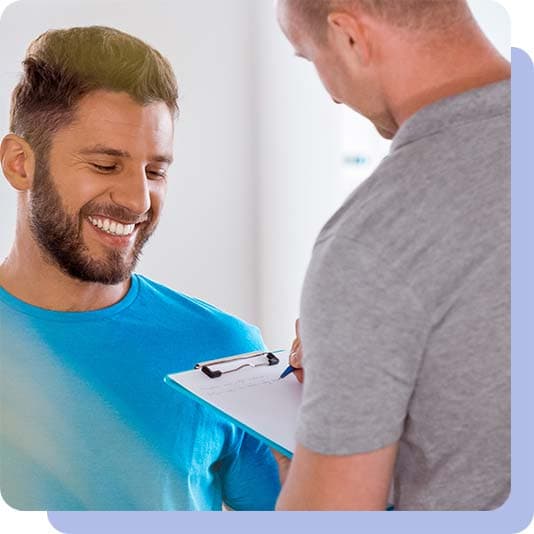 Physiotherapist and patient discussing symptoms and treatment plan