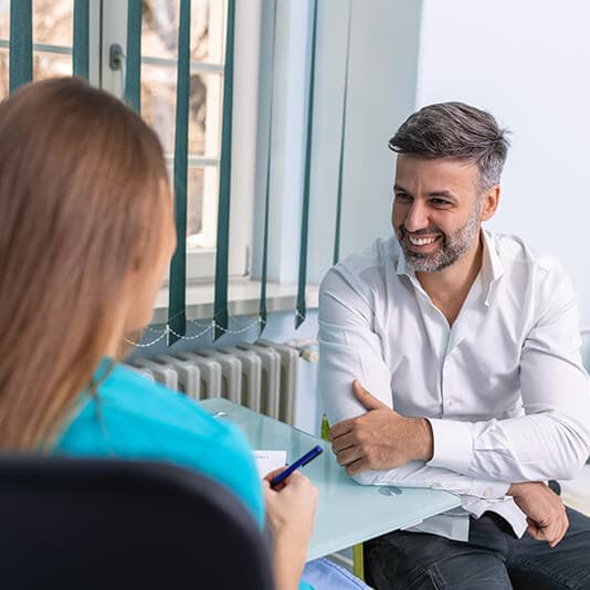 Man having a conversation with lady at work