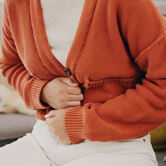 Woman holding her stomach in pain