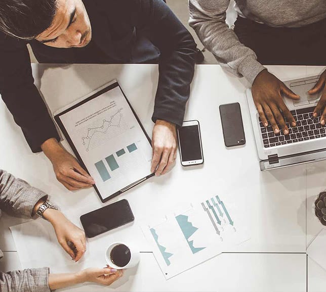 Office team collaborating with laptops and tablets